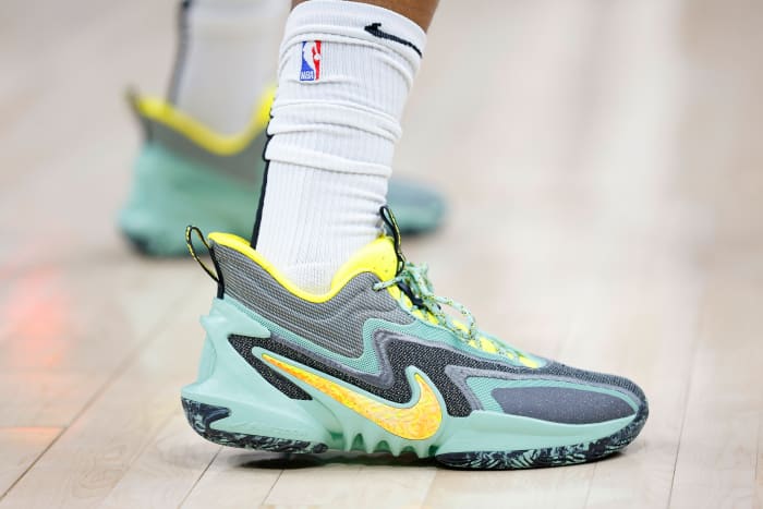 View of green and yellow Nike shoes.